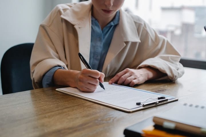 A person writing a relapse prevention plan at rehab in Birmingham or near Birmingham