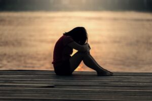 A woman sitting on a decking crying near Blackpool