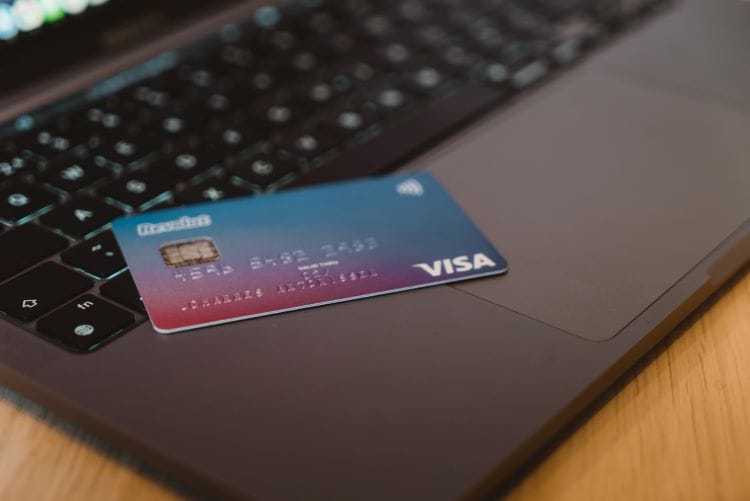 A bank card on a laptop of a person deciding whether they can claim rehab on their insurance