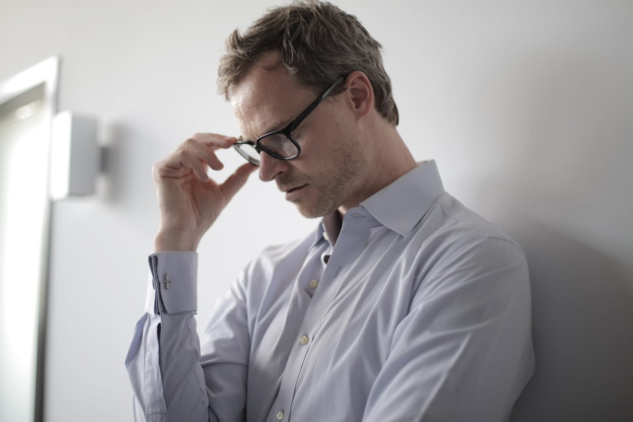 Man adjusting glasses at drug and alcohol rehab in Cornwall