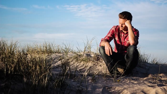 Man sat outside thinking at a drug and alcohol rehab  centre in Weston-super-Mare