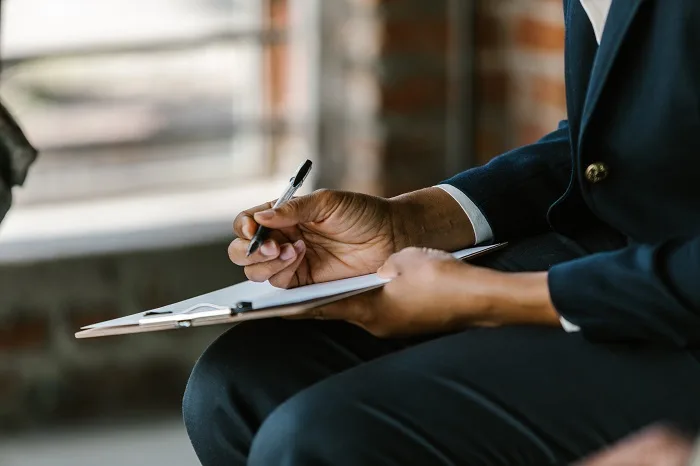 Man taking notes at a drug and alcohol rehab in Manchester