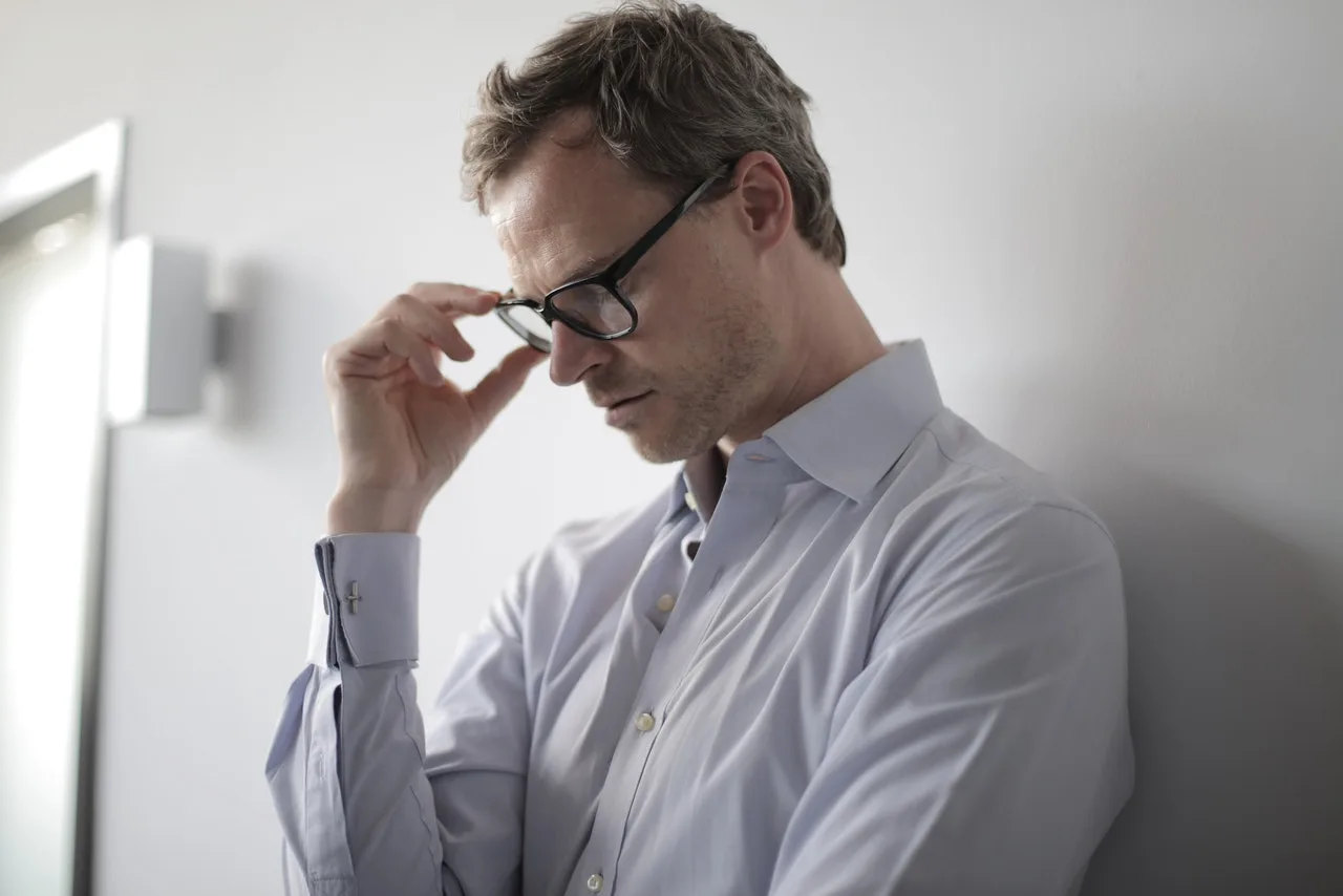 Patient adjusting glasses during alcohol and drug addiction treatment at a drug and alcohol rehab in Middlesbrough