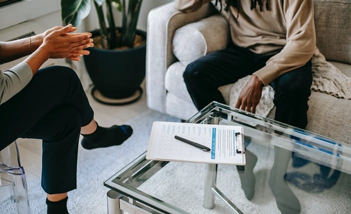 Patient and therapist talking and taking notes at a drug and alcohol rehab in Scotland or near Scotland