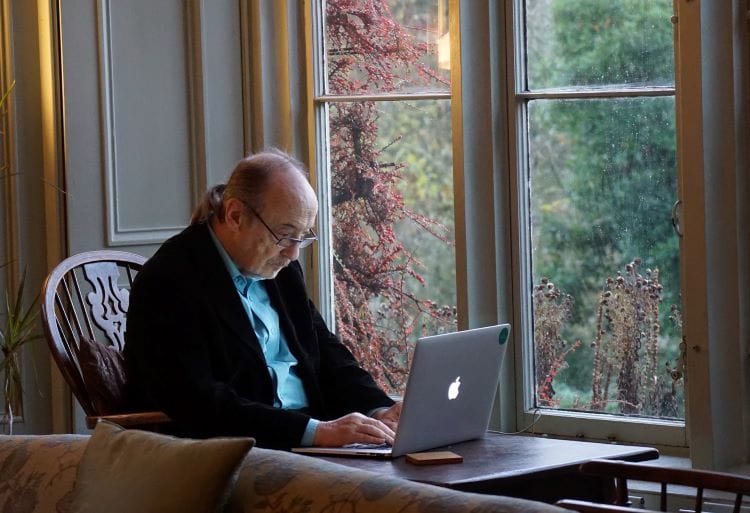 Patient typing on a laptop