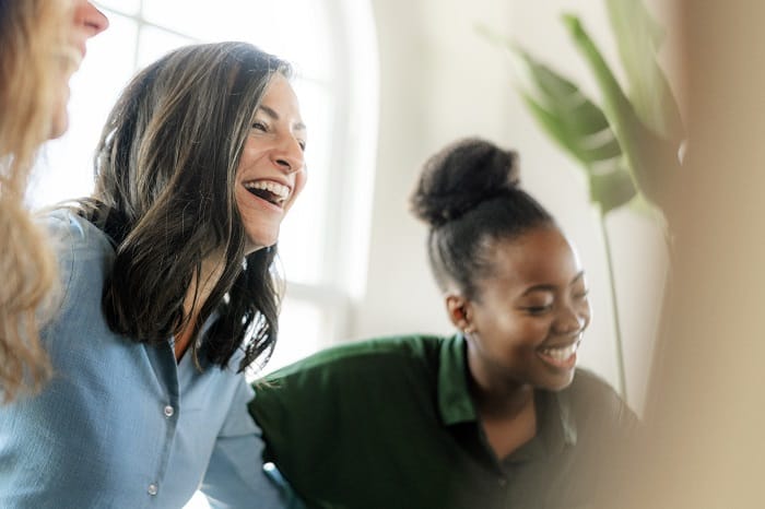 People laughing during a group therapy session at a drug and alcohol rehab clinic in Norfolk