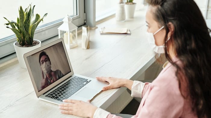 Person speaking on a laptop to a counsellor at drug and alcohol rehab in Gloucestershire or near Gloucestershire