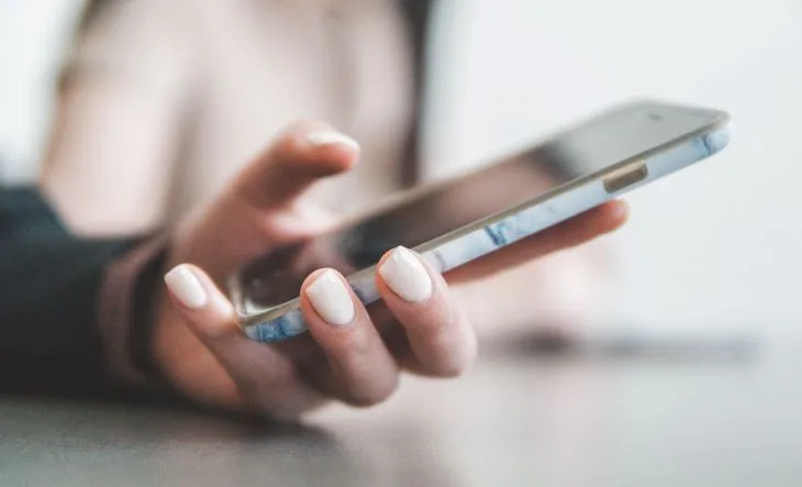 Person typing on a phone at a drug and alcohol rehab in Leicester or near Leicester