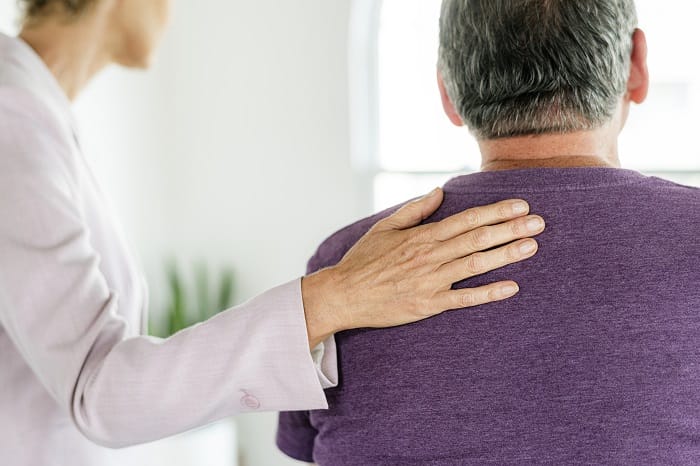 Staff member comforting a patient at a drug and alcohol rehab clinic in Norfolk