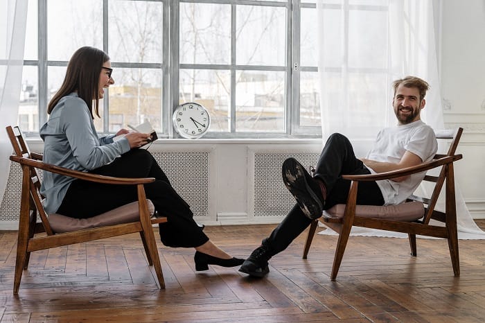 Therapist and patient laughing together at a drug and alcohol rehab clinic in the West Midlands