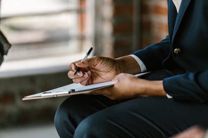 Therapist taking notes at a drug and alcohol rehab clinic in Staffordshire