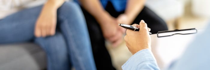 Therapist taking notes with a couple at a drug and alcohol rehab centre in Scotland