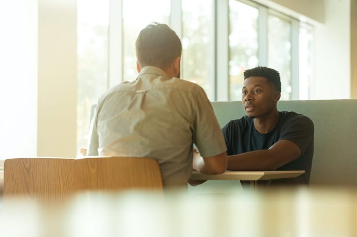 Two young people talking at a drug and alcohol rehab in Scotland or near Scotland