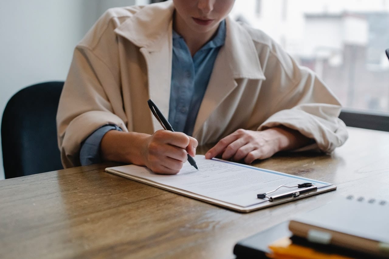 Woman filling out paperwork at drug and alcohol rehab in Cornwall