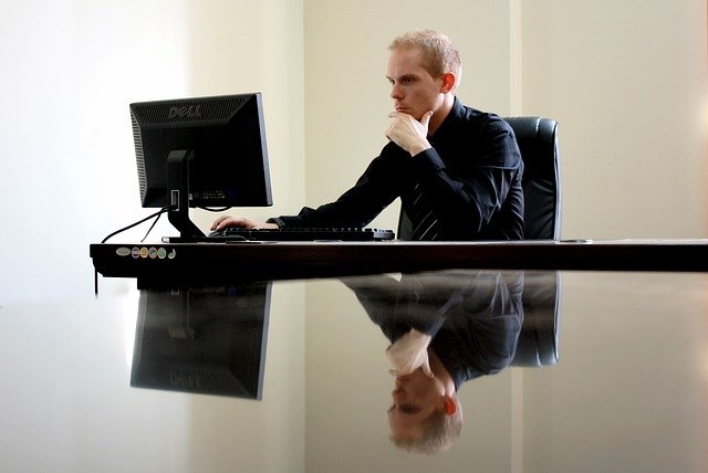 man sat at computer desk