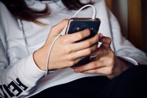 Woman on her phone at a drug and alcohol rehab in the Isle of Wight