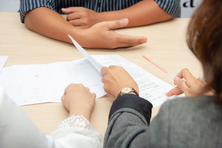 people sat at tables with papers