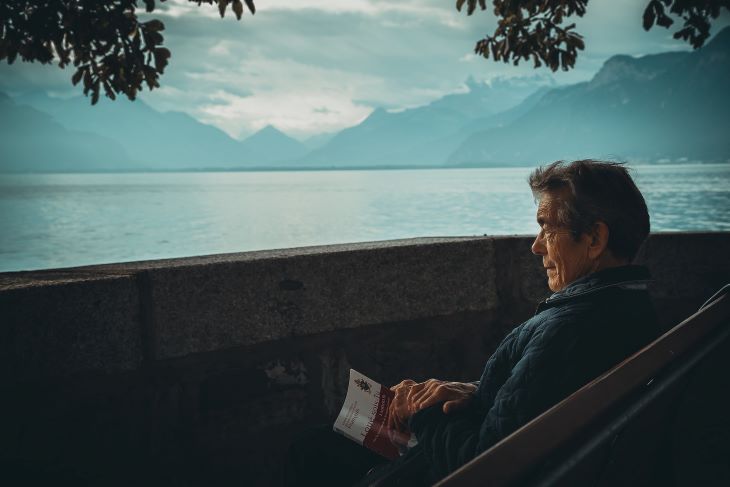 A man looking tense as he views the mountain scenery