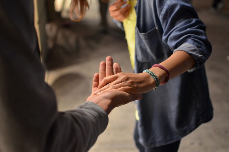 A man holding another man's hand