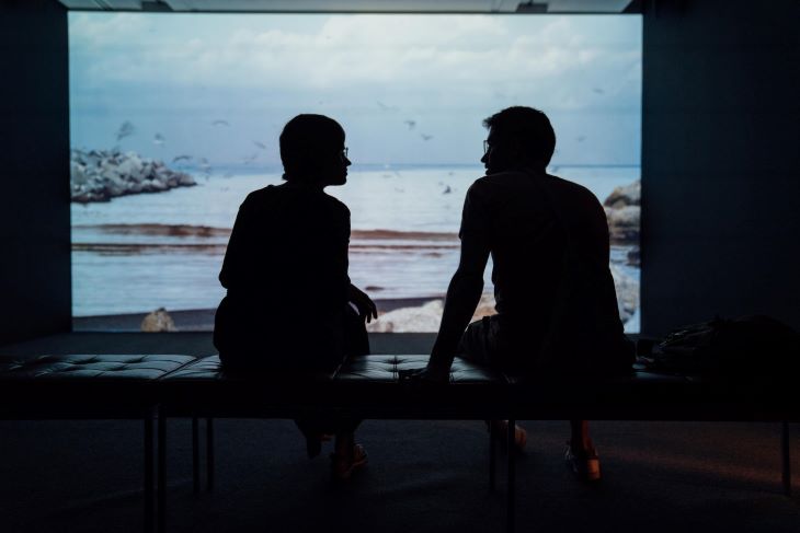 A silhouetted couple talking