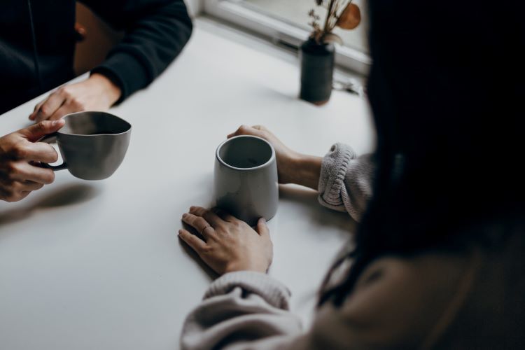Two people talking with coffee
