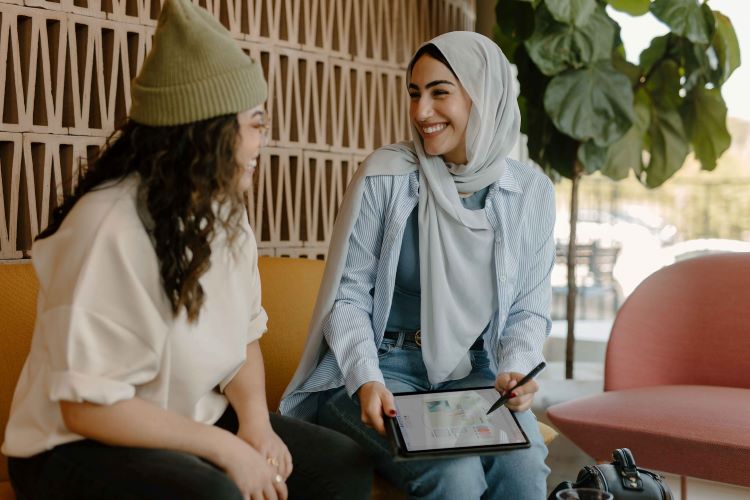 Two women smiling at each other, catching up