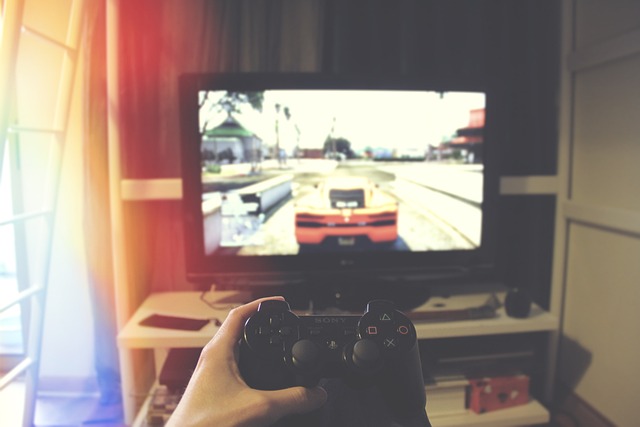 game console and close up of controller, with television in the background