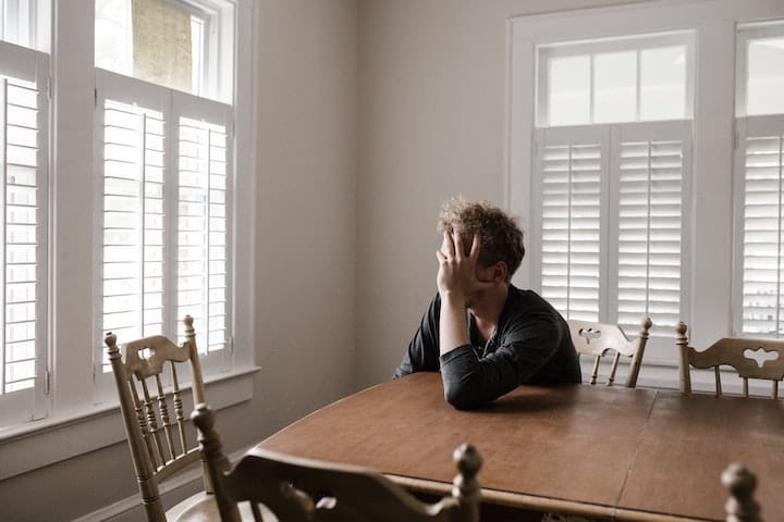 Man holding his head in hunger during Ramadan