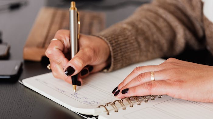 Person writing in journal, coping with death of a loved one