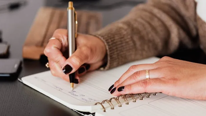 Person writing in journal, coping with death of a loved one