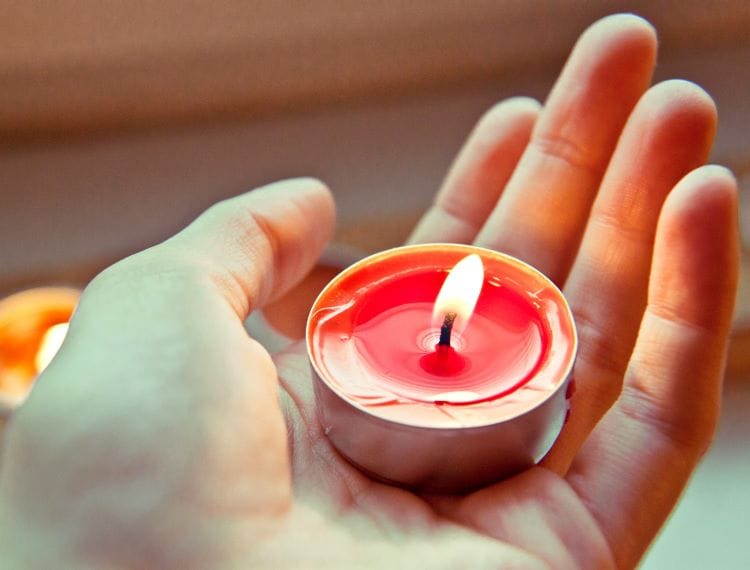 A person holding a candle