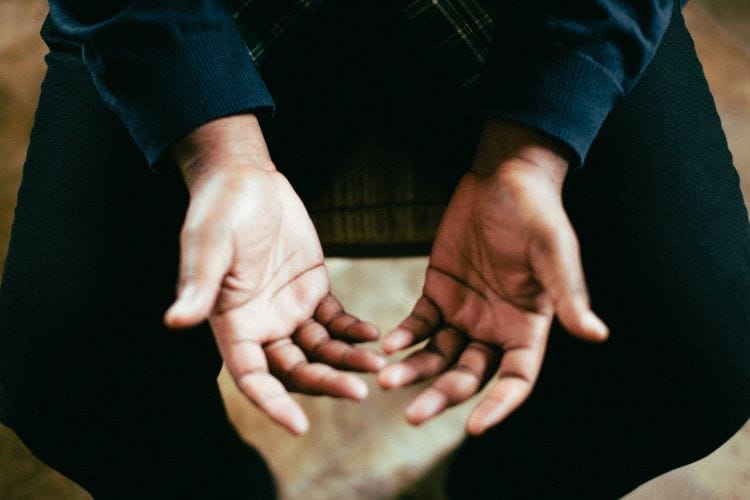 A Muslim with their palms face up in their lap