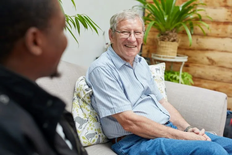 An older man smiling in a rehab clinic