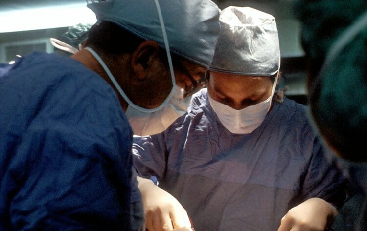 Two surgeons working on a patient with ketamine bladder