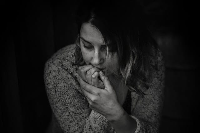 Black and white photo of a woman experiencing hangxiety