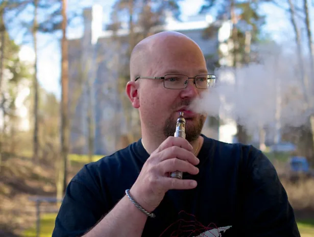 Man vaping thinking and thinking about how long it will take his lungs to heal