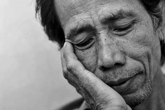 Black and white photo of an exhausted person showing the signs of misusing prescription drugs