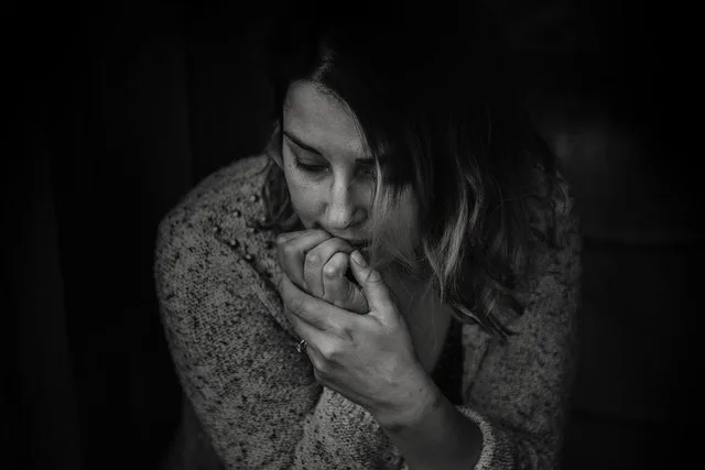 Black and white photo of a woman struggling with mental health issues