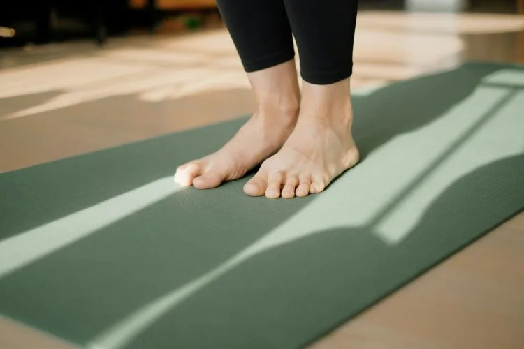 Two feet on a yoga mat