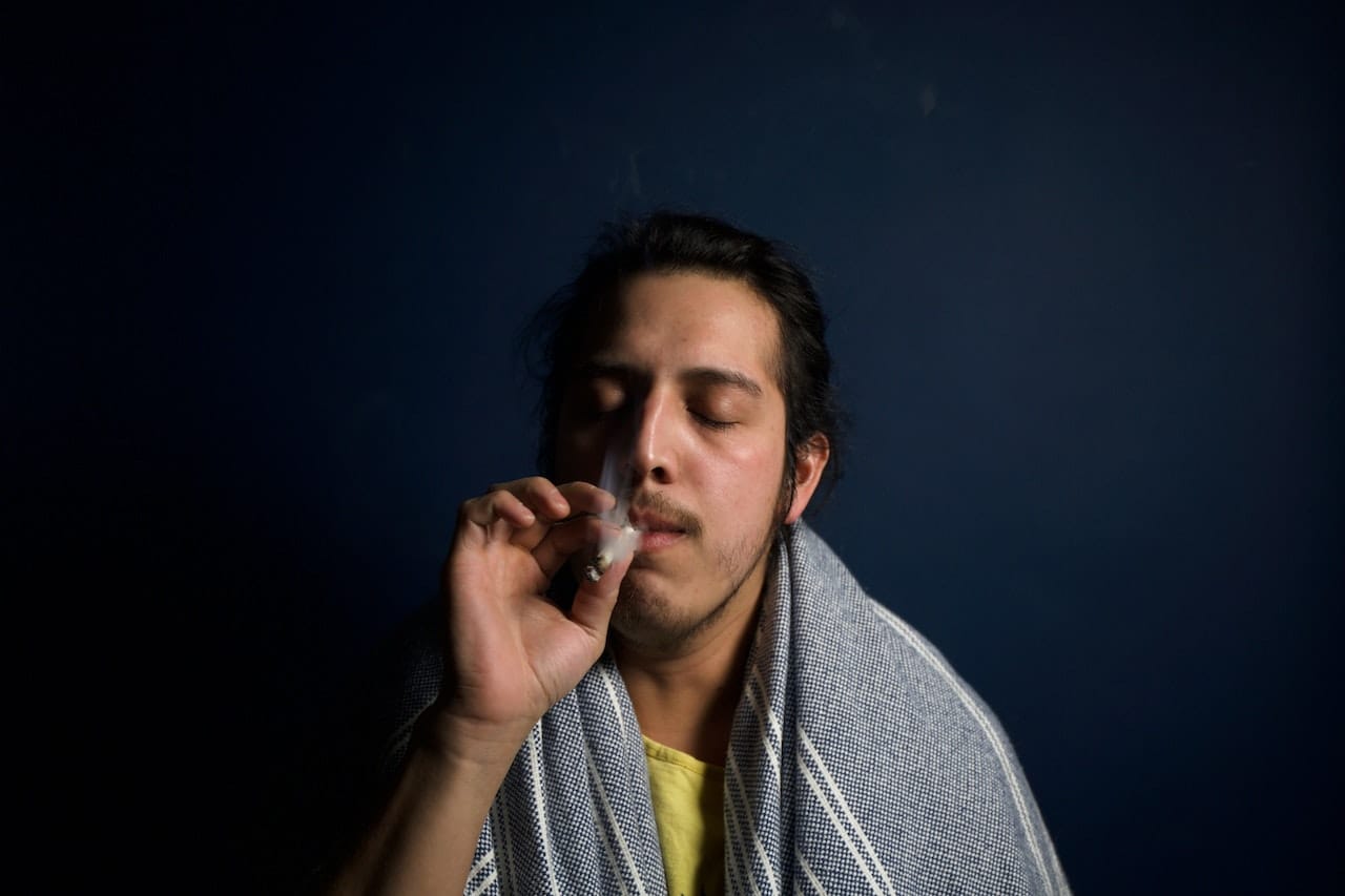 Young person smoking cannabis after underage drinking