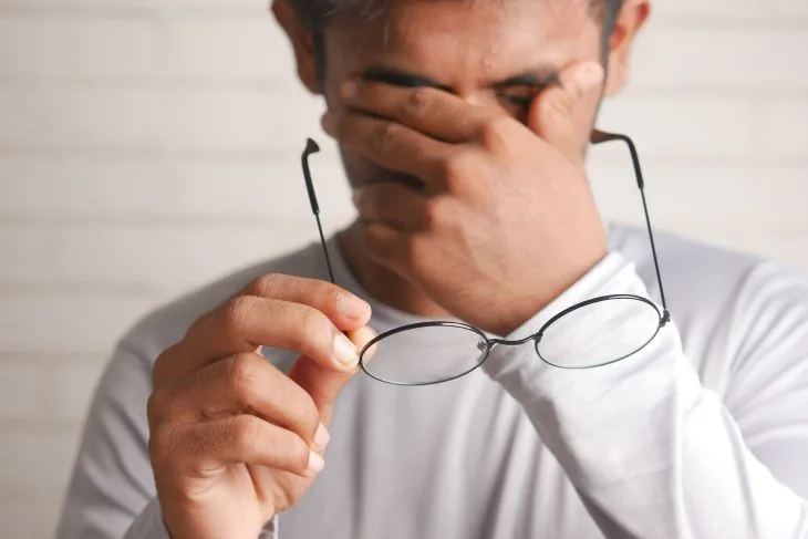 Patient rubbing his eyes and struggling with the signs of mental health challenges