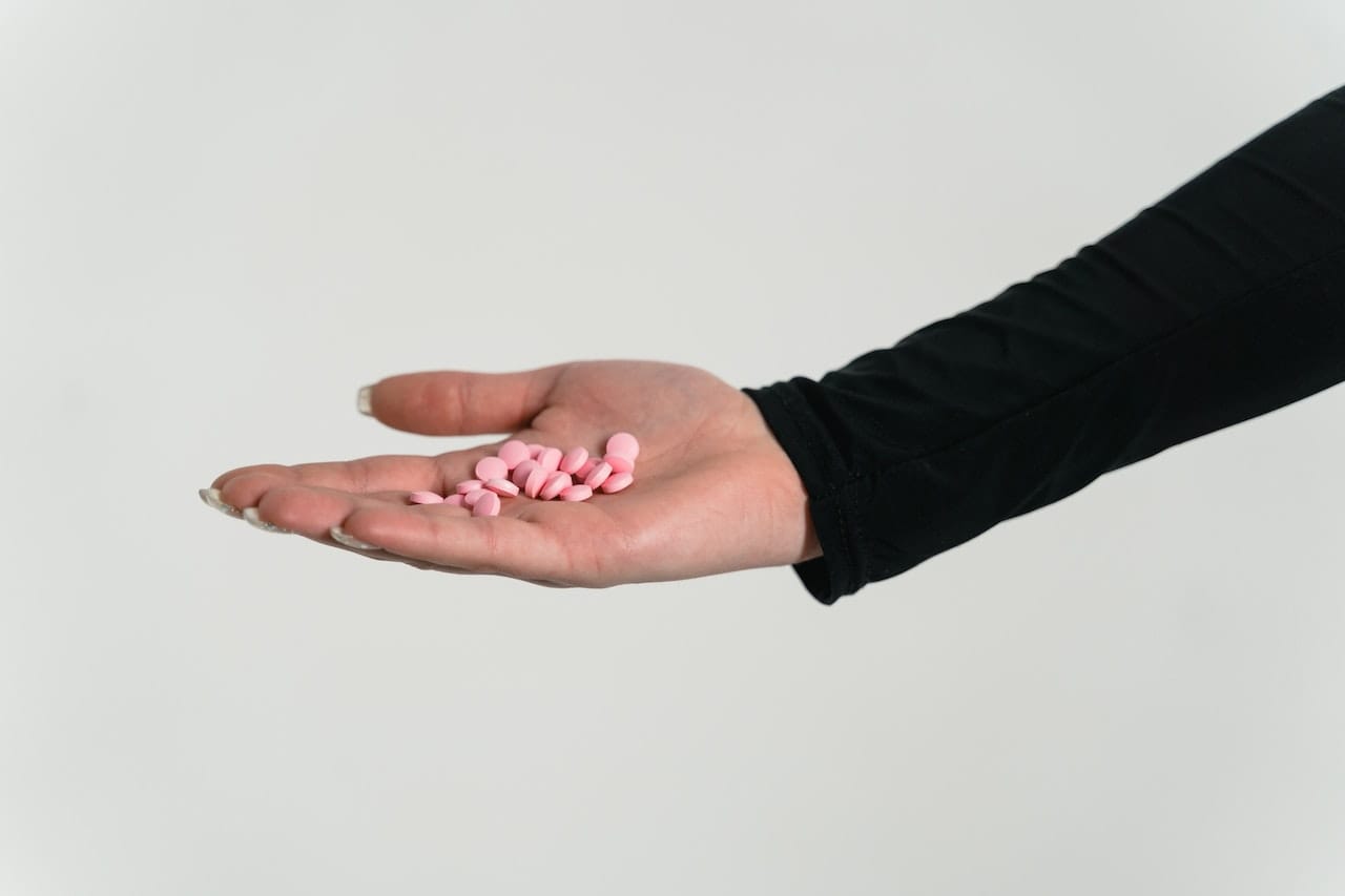 Person holding methadone pills