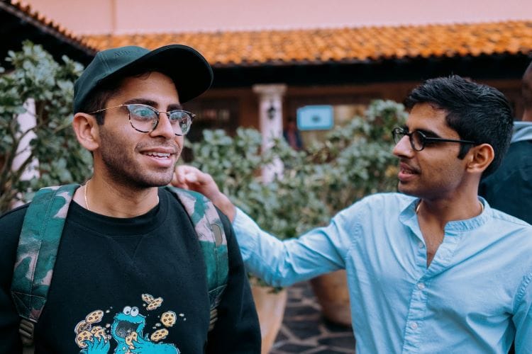 Two friends supporting each other and discussing mental health