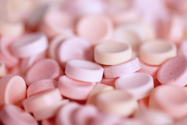 Pink pills representing pink cocaine before crushing