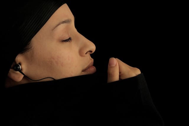 Woman wearing headphones and engaging in sound therapy