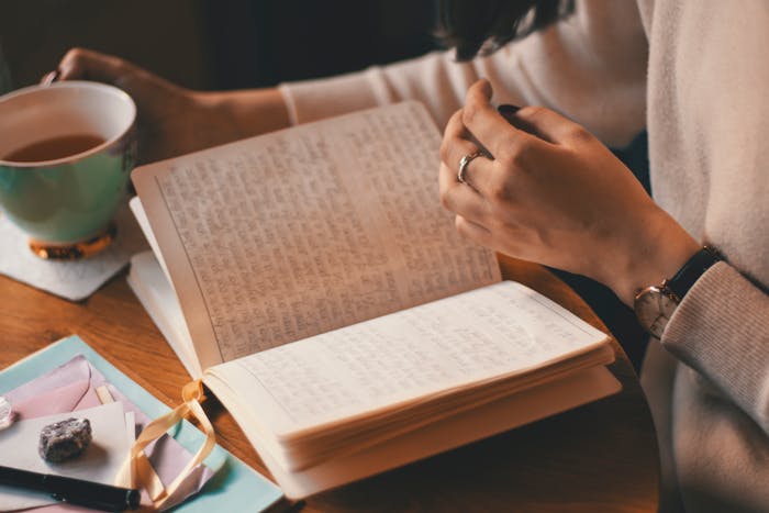 Person writing in a diary in Liverpool
