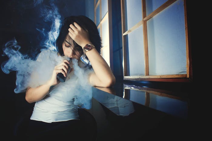Someone vaping a single use disposable vape