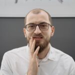 Someone who uses snus, touching their mouth