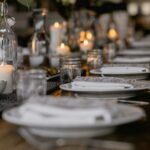 A table laid for a dinner party with white plates