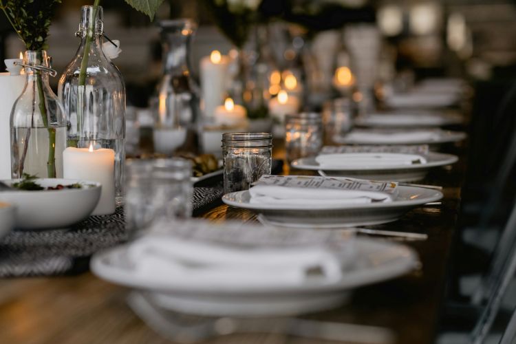 A table laid for a dinner party with white plates